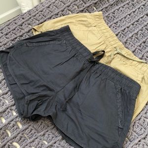 Two pairs of shorts. Dark navy and an olive green
